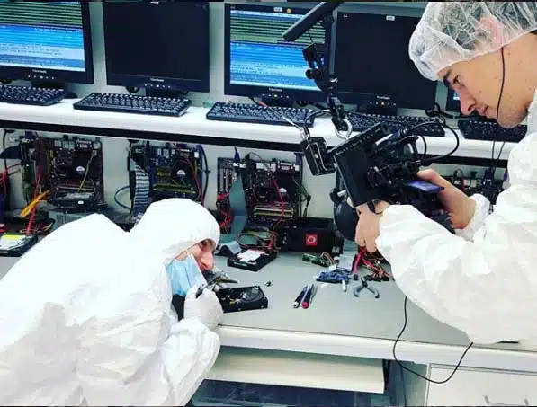 Linus Tech Tips attempting an actuator swap on an HDD hard disk drive in the DriveSavers cleanroom